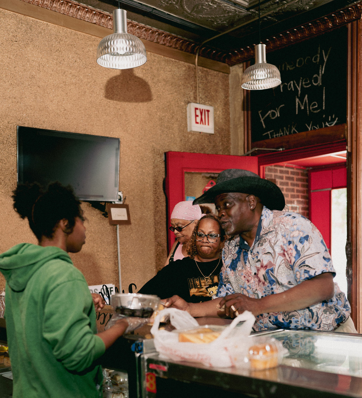 A Brown Sugar Bakery team member handing a pickup order across the counter